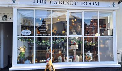 The Cabinet Room shop - a Grade II listed building with glass window panes and antiques on the inside.