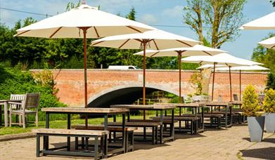 Undercover dining terrace by a bridge.