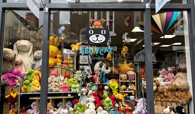 Shop front of Bill and Bert's with lots of colourful Jellycat teddies