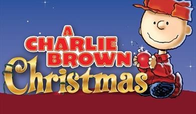 Charlie Brown sits holding a Christmas bauble alongside the words: A Charlie Brown Christmas