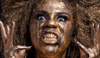 Image shows Desiree Burch in gold