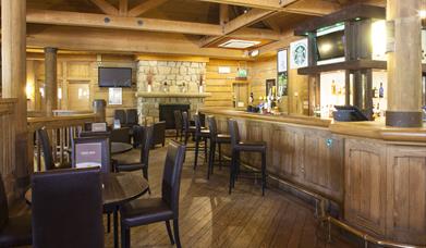 Bar area with tables and chairs and bar stools