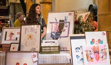Image shows market stalls in Colchester Arts Centre for a Christmas fair.