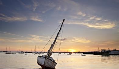 Sailing boat on Mersea Island at sunset