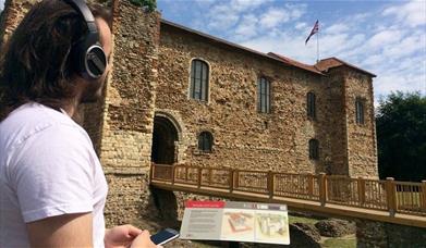 Listening to an audio tour by Colchester Castle