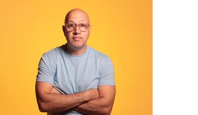 Image shows Sam Avery with arms crossed.