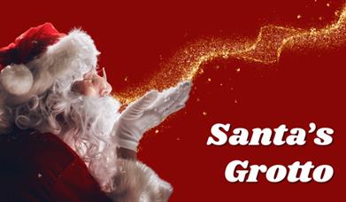 Image shows Santa blowing a trail of sparkles