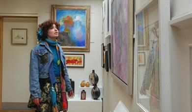 Lady looking at artwork in the Sentinel Gallery