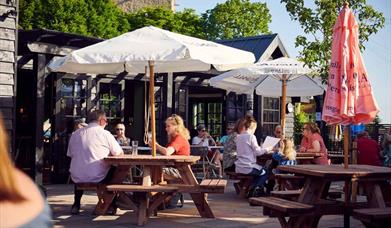 People sat outside the White hart Inn enjoying a drink in the sunshine