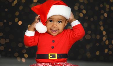 Toddler dressed in a Santa outfit