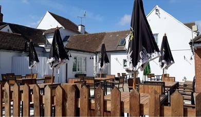 Outdoor seating area with dark wooden benches.